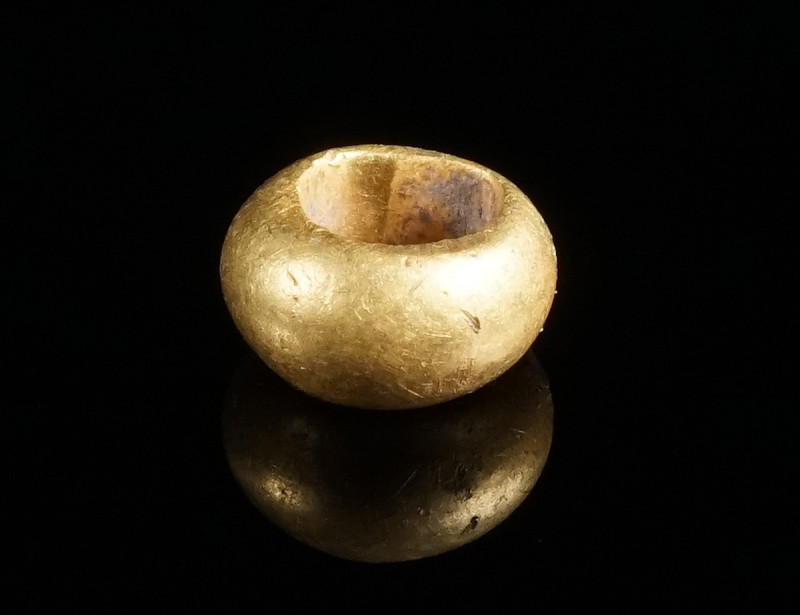 A PREHISTORIC GOLD BEAD Circa 2nd-1st millennium BC. Biconical bead with large h...