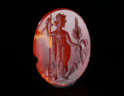 A ROMAN CARNELIAN INTAGLO WITH THE GODDESS CERES Circa 1st-3rd century AD. Oval intaglio showing Ceres standing right, holding sceptre, poppy, and an ...