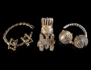 A GROUP OF THREE HIGHLY ELABORATE SLAVIC TEMPLE RINGS Circa 10th-11th century AD. Two silver-gilt temple rings, filigree (one fragmented); and a silve...