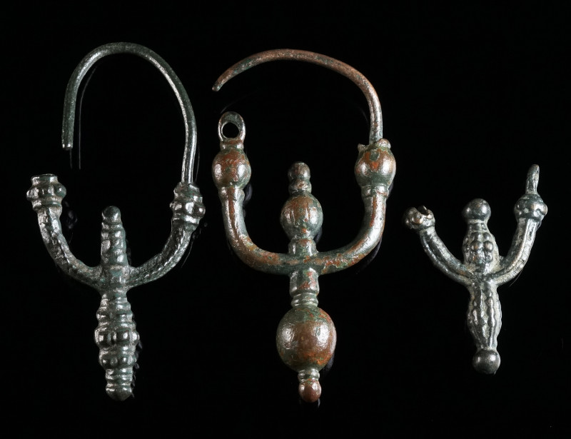 A GROUP OF THREE SLAVIC BRONZE EARRINGS Circa 9th-11th century AD. Three decorat...