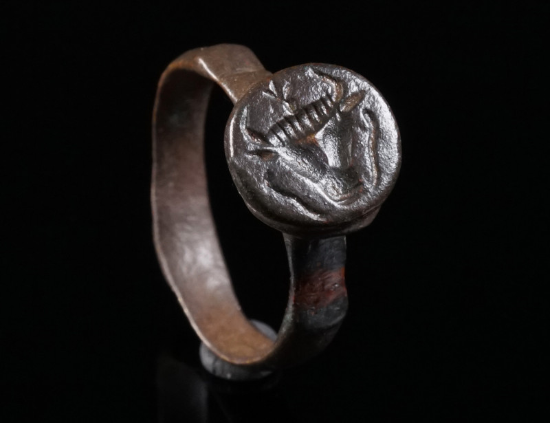 A BYZANTINE BRONZE RING WITH A BULL’S HEAD Circa 5th-7th century AD. With offset...