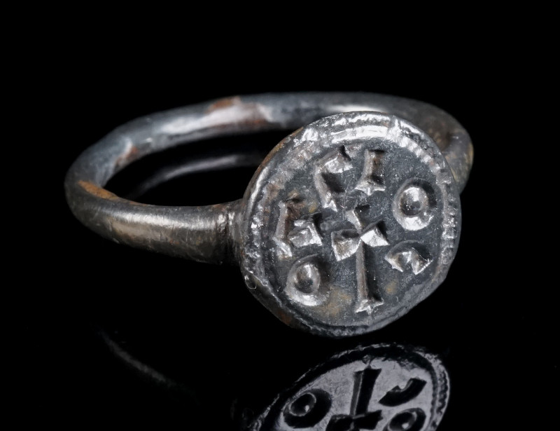 AN EARLY BYZANTINE BRONZE RING WITH INSCRIPTION AND CROSS Circa 6th-7th century ...