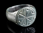 A MEDIEVAL BRONZE RING WITH A STAR Circa 13th-15th century AD. With a circular bezel and an engraved star design. Ring size 53 (EU)

Ex European priva...