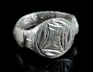 A MEDIEVAL BRONZE RING WITH GEOMETRIC DESIGN Circa 13th-15th century AD. With decorated circular bezel and offset shoulders. Ring size 54 (EU)

Ex Eur...