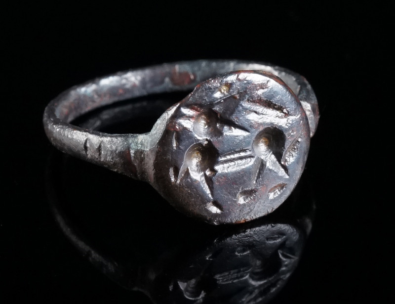A LATE ANTIQUE BRONZE RING WITH A STYLISED ANIMAL Circa 4th-6th century AD. Ring...