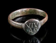 A LATE ROMAN BRONZE RING WITH INSCRIPTION Circa 4th century AD. The drop-shaped bezel is engraved with the word VIV/AS. Ring size 53 (EU)

Ex European...