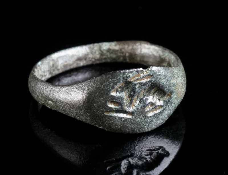 A ROMAN BRONZE RING WITH A HARE Circa 2nd-3rd century AD. The oval bezel is engr...