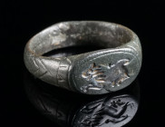 A BYZANTINE BRONZE RING WITH A LION Circa 6th-8th century AD. The oval bezel engraved with a lion jumping to the left. Ring size 52 (EU)

Ex European ...