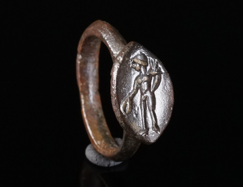 A ROMAN BRONZE RING WITH A GENIUS Circa 3rd century AD. With a navette-shaped be...