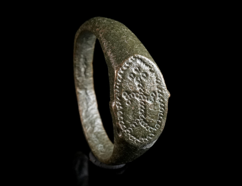 AN EARLY BYZANTINE BRONZE RING WITH A CROSS Circa 6th-7th century AD. With an ov...