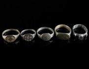 A GROUP OF FIVE MEDIEVAL/EARLY MODERN BRONZE RINGS Circa 14th-16th century AD. All with decorated bezel. Ring size 48-57 (EU)

Ex private collection, ...