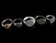 A GROUP OF FIVE MEDIEVAL/EARLY MODERN BRONZE RINGS Circa 14th-16th century AD. All with decorated bezel. Ring size 44-57 (EU)

Ex private collection, ...