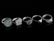 A GROUP OF FIVE SMALL MEDIEVAL/EARLY MODERN BRONZE RINGS Circa 14th-16th century AD. All with decorated bezel. Outer diameter 17-18 mm

Ex private col...