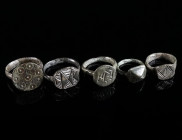 A GROUP OF FIVE SMALL MEDIEVAL/EARLY MODERN BRONZE RINGS Circa 14th-16th century AD. All with decorated bezel. Outer diameter 14-17 mm

Ex private col...