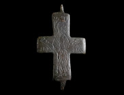 A BYZANTINE BRONZE RELIQUARY CROSS WITH A SAINT Circa 10th-12th century AD. One half of a reliquary cross (enkolpion) depicting a saint with his hands...