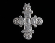 A DECORATED BYZANTINE SILVER CROSS PENDANT WITH INSCRIPTION Circa 11th-13th century AD. On the obverse in the centre a medallion depicting a bust of C...