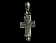 A BYZANTINE BRONZE RELIQUARY CROSS WITH CHRIST AND MARY Circa 10th-12th century AD. A small reliquary cross (enkolpion) depicting Christ crucified wit...