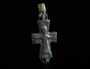 A BYZANTINE BRONZE RELIQUARY CROSS WITH CHRIST AND MARY Circa 10th-12th century AD. A small reliquary cross (enkolpion) depicting Christ crucified on ...