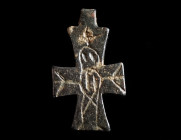 A BYZANTINE LEAD CROSS PENDANT Circa 6th-11th century AD. Small solid cross pendant depicting Christ crucified with a cross above his head in a highly...