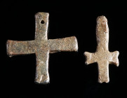 TWO BYZANTINE LEAD CROSS PENDANTS Circa 6th-11th century AD. Small solid cross pendants with a loop/hole for suspension. H 29 mm, and H 31 mm

Ex priv...