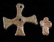 TWO SMALL BYZANTINE LEAD CROSSES Circa 6th-12th century AD. A small, decorated cross, and a plain solid cross with two holes for attachment. H 21 mm, ...