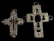 TWO DECORATED BRONZE CROSSES Circa 17th-18th century AD. Two openwork crosses with elaborate decoration and rings for attachment/suspension. H 51 mm, ...