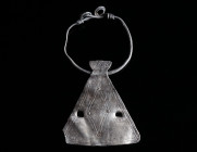 A ROMANO-CELTIC SILVER AXE PENDANT Circa 1st century AD. A richly decorated axe pendant with suspension hoop. One edge of the pendant broken, pendant ...