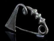 A GRAECO-THRACIAN BRONZE BOW BROOCH Circa 7th-6th century BC. The bow decorated with three knobs. With triangular catch plate; spring and pin. L 38 mm...