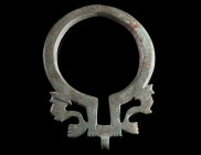 A ROMAN BRONZE RING BROOCH WITH DOLPHINS Circa 3rd-4th century AD. Late Roman ring brooch with two stylised dolphins in openwork design. Minor remains...