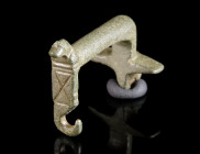 A ROMAN KNEE BROOCH WITH HORSE HEAD Circa 2nd-3rd century AD. Knee brooch with foot terminating in a small, stylised horse head. Spring and pin missin...