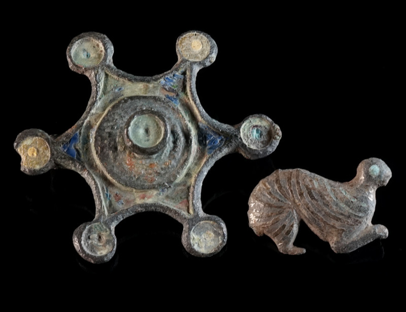 TWO ROMAN BRONZE BROOCHES Circa 1st-2nd century AD. A star shaped disk brooch wi...