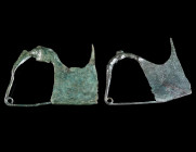 TWO GREEK-TYPE BOW BROOCHES Circa 7th-6th century BC. Both with large catch plate. Catch plate of one brooch repaired, and pins probably reattached/re...