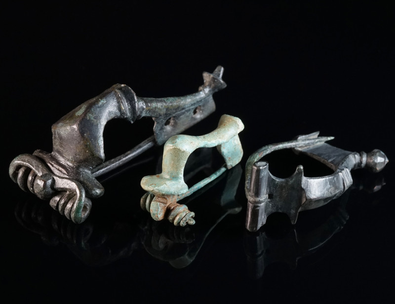 A GROUP OF THREE ROMAN BRONZE BROOCHES Circa 2nd-3rd century AD. A strongly prof...