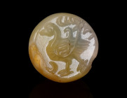 A SMALL SASANIAN CHALCEDONY STAMP SEAL WITH A BIRD Circa 3rd-7th century AD. Stamp seal with a bird, two crescents, and an inscription; the centre per...