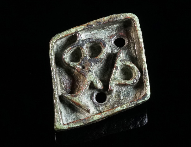 A BYZANTINE BRONZE BREAD STAMP Circa 5th-8th century AD. Rhomboid in form, with ...