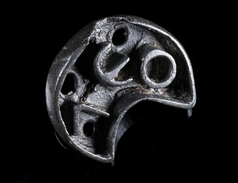 A CRESCENT-SHAPED BYZANTINE BRONZE BREAD STAMP Circa 5th-8th century AD. With an...