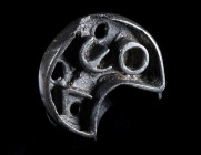 A CRESCENT-SHAPED BYZANTINE BRONZE BREAD STAMP Circa 5th-8th century AD. With an abbreviated Greek inscription and a solid loop handle at the back. L ...