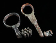 TWO ROMAN BRONZE KEYS Circa 1st-3rd century AD. One with a head with loop and a long shank with offset bit; the other a key ring with short projecting...