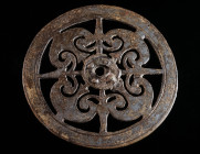 A LARGE ROMAN BRONZE OPENWORK MOUNT Circa 1st-3rd century AD. Circular mount with pelta-shaped decoration. With some remains of toned tinning. Possibl...