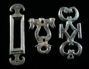 A GROUP OF THREE ROMAN BRONZE OPENWORK BELT FITTINGS Circa 2nd-3rd century AD. Two with a pelta-shaped design, and one with stylised horse heads. L 39...