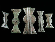 A GROUP OF FIVE LATE ROMAN BRONZE PROPELLOR-TYPE FITTINGS Circa 4th-5th century AD. Four decorated propellor-type belt fittings of different sizes (tw...