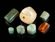 A GROUP OF SEVEN ANCIENT BEADS Circa 1st-4th century AD. Three hexagonal emerald beads, a hexagonal aventurine quartz bead, a hexagonal bone bead (gre...