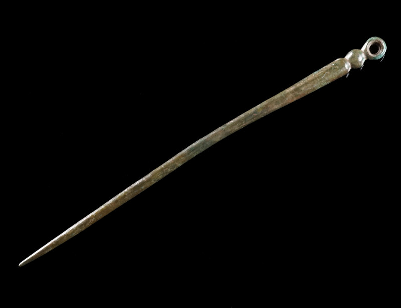 A ROMAN BRONZE HAIRPIN Circa 1st-3rd century AD. A hairpin with a profiled head ...