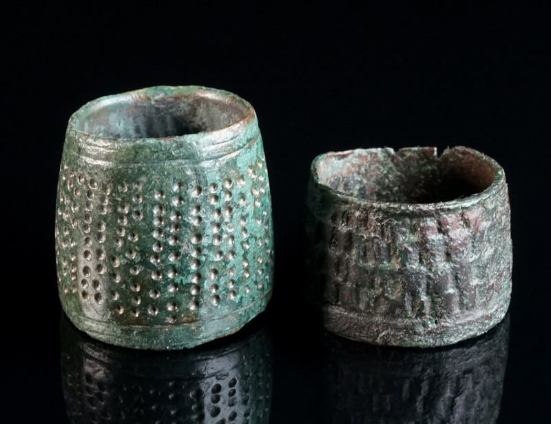 TWO BYZANTINE BRONZE THIMBLES Circa 9th-12th century AD. Two thimbles with an op...