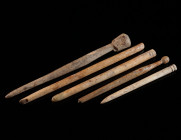 A GROUP OF FIVE ROMAN BONE HAIRPINS Circa 1st-4th century AD. With plain or decorated heads; pointed ends mostly broken, or broken and resharpened. L ...