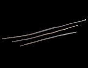 A ROMAN BRONZE HAIRPIN AND TWO INSTRUMENS/TOOLS Circa 1st-3rd century AD. A hairpin with decorated head, a sewing needle, and an instrument with a poi...