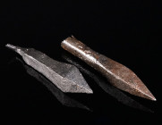 TWO HEAVY MEDIEVAL IRON CROSSBOW BOLTS Circa 14th-15th century AD. Both heads four-sided with sharp pyramid-shaped tips; one with socket, the other wi...