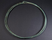 A EUROPEAN LATE BRONZE AGE TWISTED TORQUE Circa 10th-8th century BC. Composed from one long piece of twisted bronze rod doubled up, the double hoop fo...