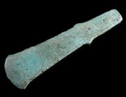 A BRONZE AGE LUGGED AXE Circa 2nd millennium BC. Copper alloy axe with two strong angular lugs ('Ärmchenbeil'). With an uneven patina, chipped at the ...