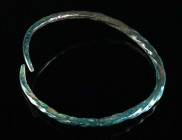 A EUROPEAN LATE BRONZE AGE BRACELET Circa 10th-8th century BC. Formed from a twisted bronze rod, tapering towards the plain ends; somewhat bent. Beaut...
